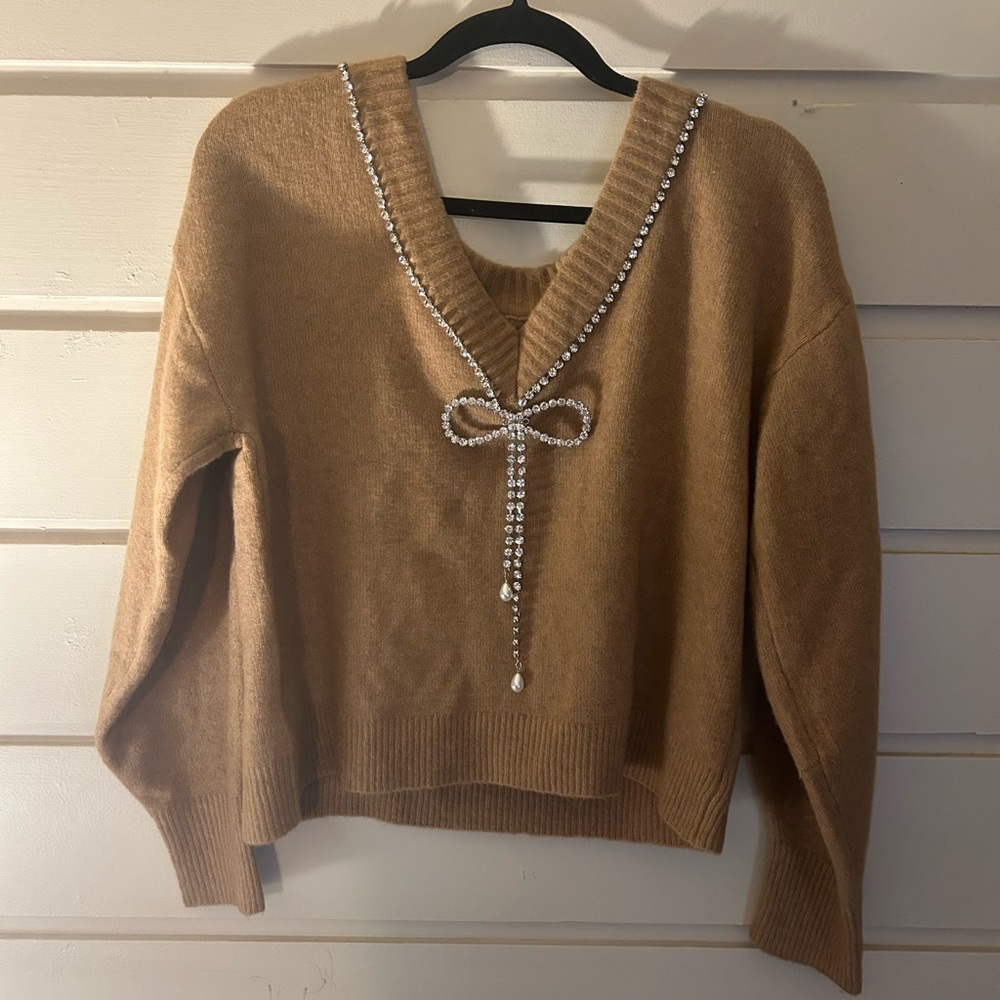 Express adorable tan brown, bedazzled V-neck line bow sweater